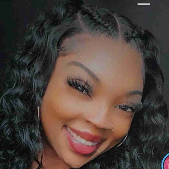 Client smiling in a fresh curly frontal install by Ke'Ebonie Hill